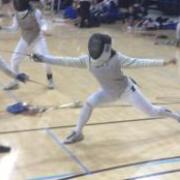 Woman fencing in a gym